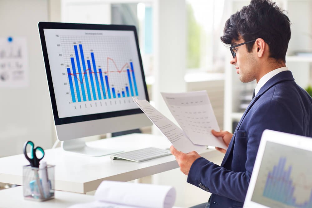 Social media reporting and performance analytics dashboard on a phone and laptop